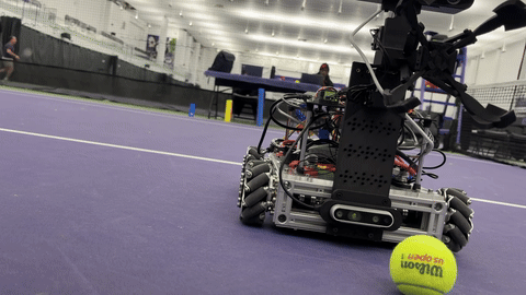 Claw picking up a tennis ball on the court